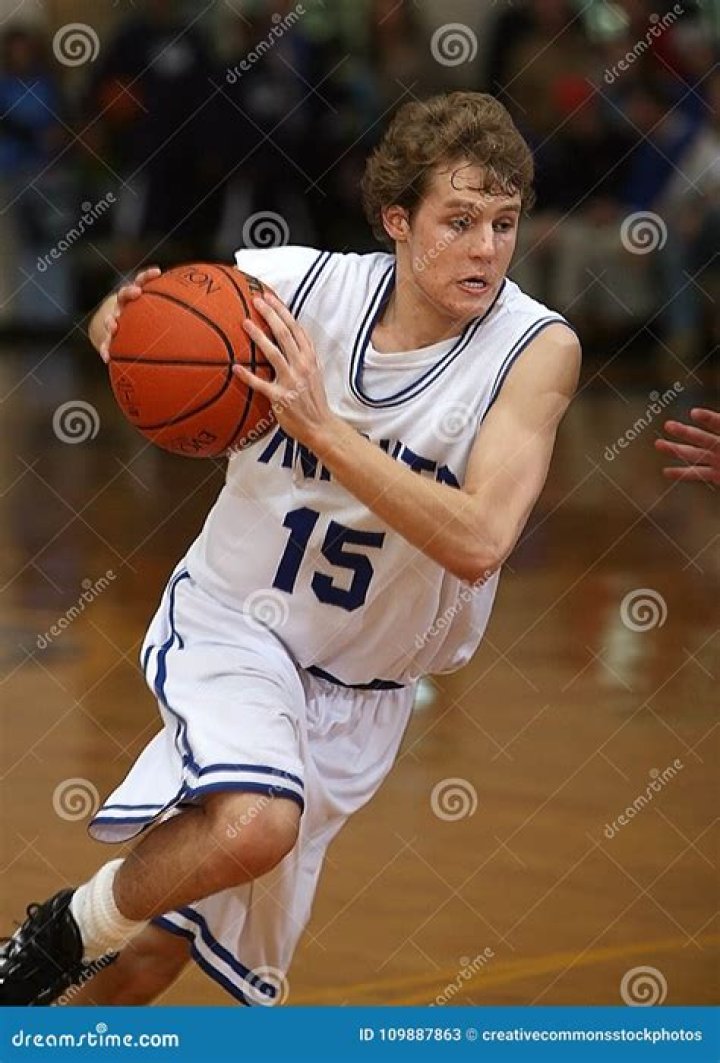Boy in Basketball Jersey Carrying Basketball at Basketball Court &middot; Free